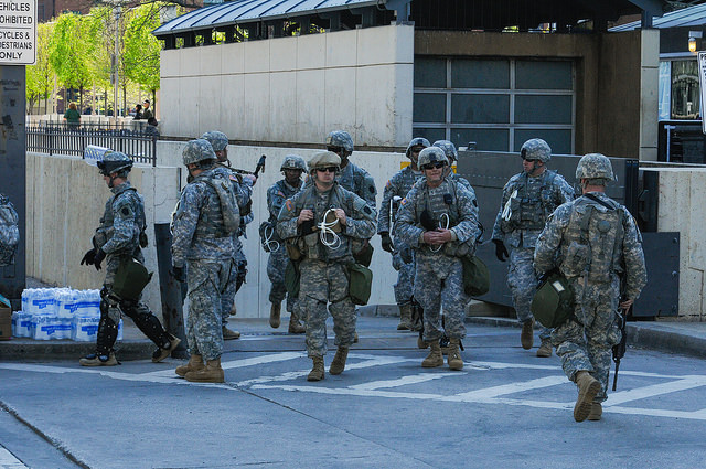 Maryland National Guard. Members of the Maryland National Guard’s 175th Infantry Regiment patrol on East Pratt Street at the Inner Harbor to protect Baltimore citizens April 28, 2015. After a violent gathering last night, Governor Larry Hogan issued a state of emergency and activated the National Guard. Photo credit: Staff Sgt. Michael Davis Jr., Maryland National Guard Public Affairs Office. Flickr/(CC BY-ND 2.0)