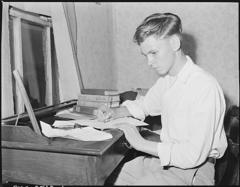 Louis Sergent, 16, who is in his first year at high school, does his homework. Both he and his father are determined that he will finish high school and not work in the coal mines. With the exception of Lucy who is blind and attended the State School for The Blind, Louis is the first member of the family to finish grade school. P V & K Coal Company, Clover Gap Mine, Lejunior, Harlan County, Kentucky. Date 13 September 1946. Russell Lee (Public domain), via Wikimedia Commons