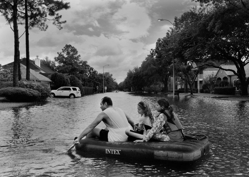 A family in Katy, just west of Houston, floats on an inflatable mattress. PHOTOGRAPHER: PHILIP MONTGOMERY FOR BLOOMBERG BUSINESSWEEK