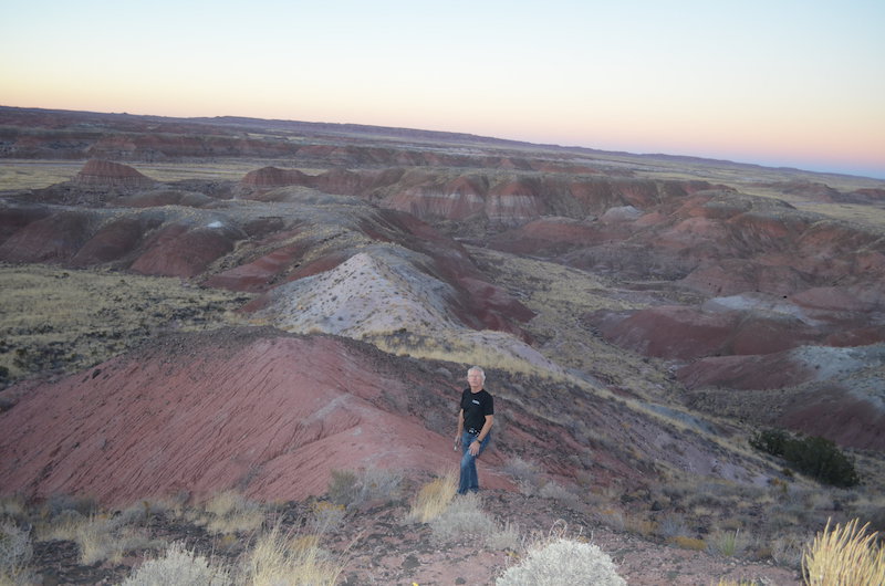 Within ancient rocks in Arizona's Petrified Forest National Park, scientists have identified signs of a regular variation in Earth's orbit that influences climate. Here, one of the authors near the research site. Credit: Kevin Krajick/Lamont-Doherty Earth Observatory
