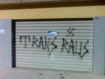 Transphobic graffiti in Rome, meaning "trans out" in German, with a swastika. Atreliu, CC BY-SA 3.0 <https://creativecommons.org/licenses/by-sa/3.0>, via Wikimedia Commons